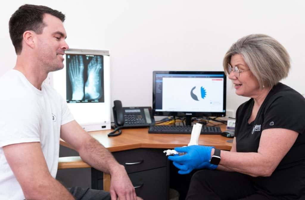 Podiatrist Angela Holland consultation with patient experiencing foot pain