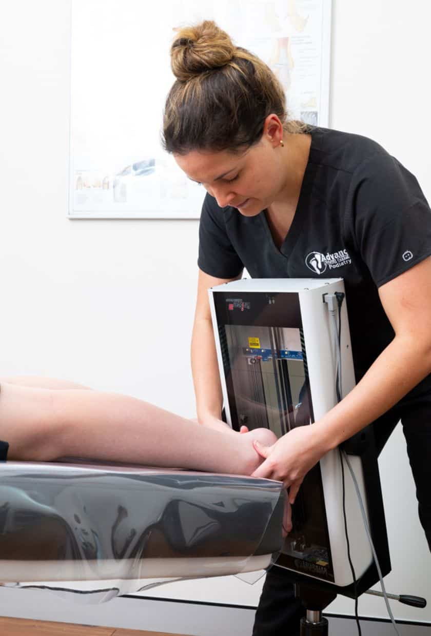 Podiatrist doing a 3D scan on the foot during Custom Orthotics