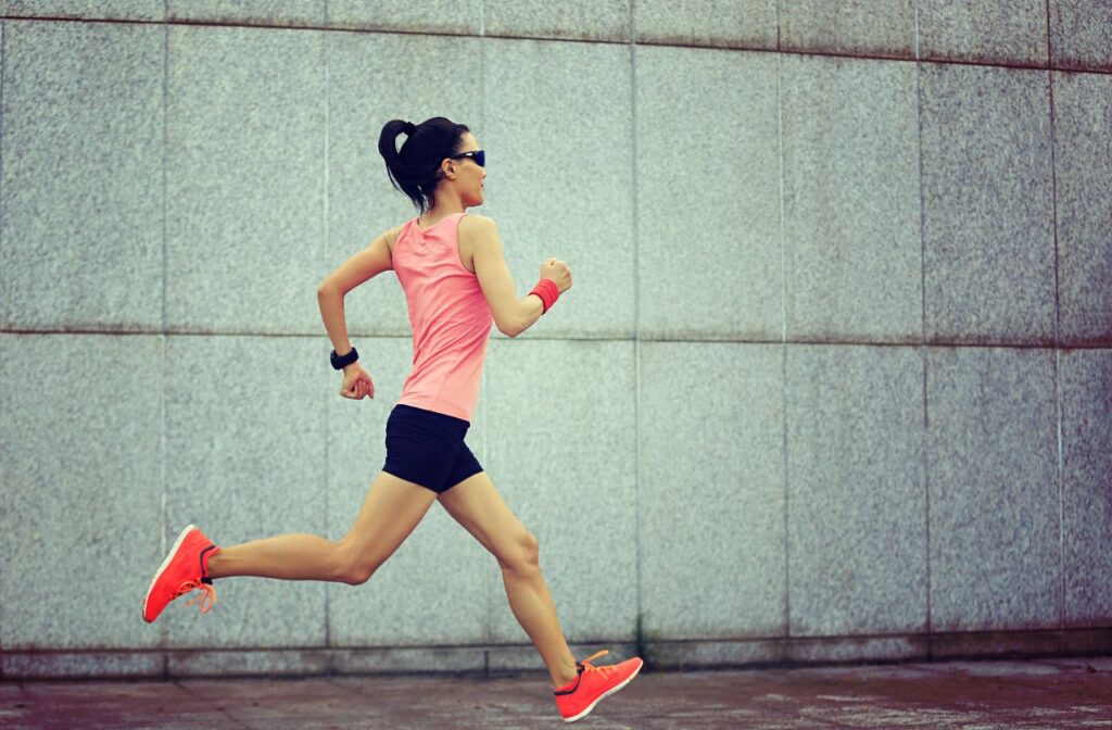 Woman dressed in brightly coloured athletic clothing running