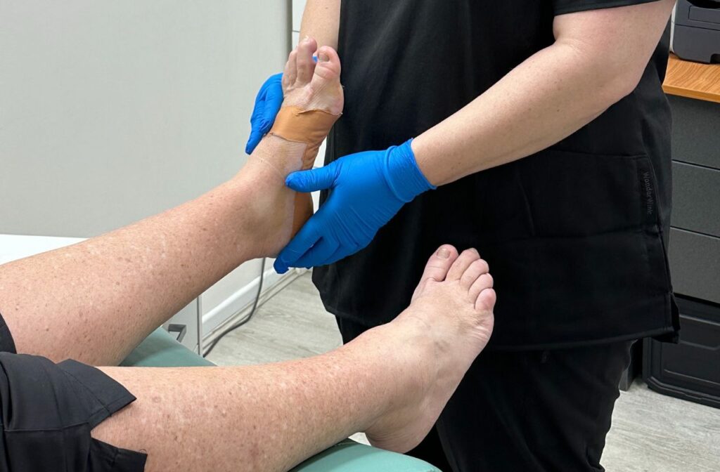 Podiatrist manipulating a patients foot to help with recovery from top of foot pain