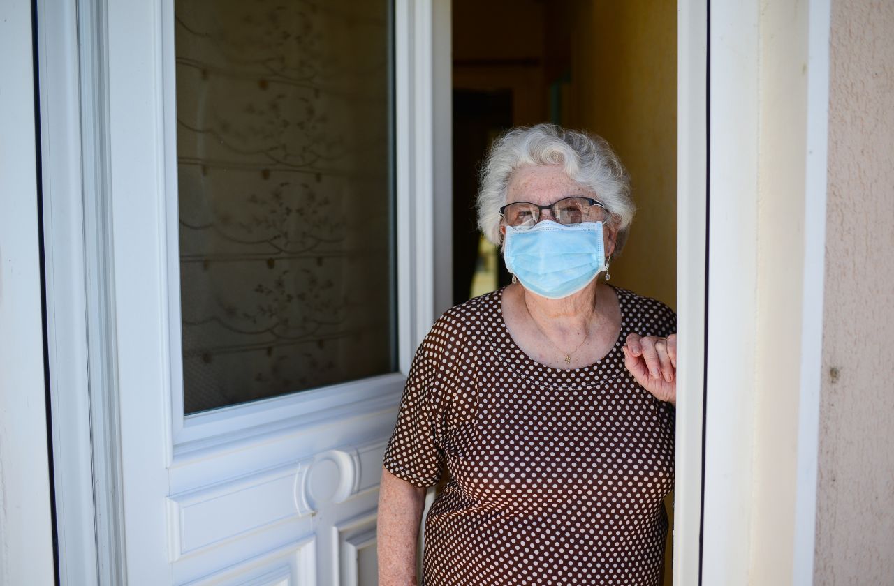 Senior woman wearing a mask prepared for her mobile podiatry appointment.