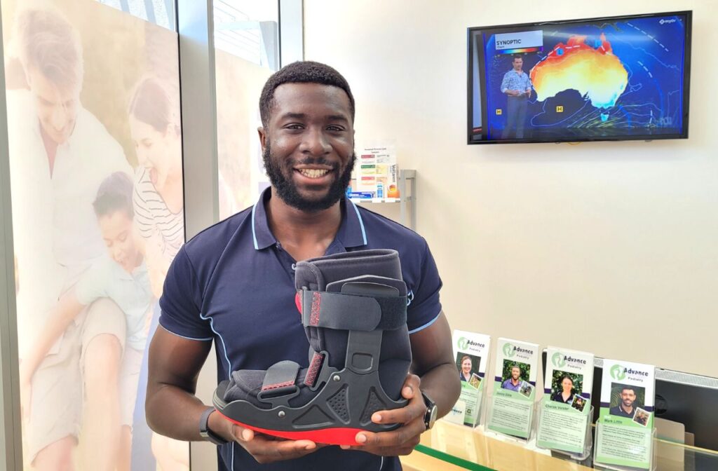 Man holding a medical moon boot